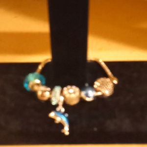 Silver Metal Cord Charm Style Bracelet with Dolphin Charm & Blue Sparkles